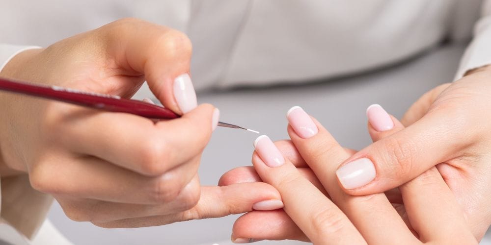 Woman getting a manicure at a nail salon.