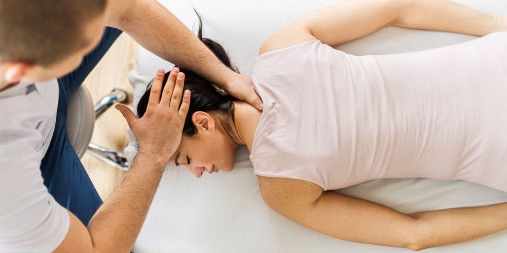 Woman receiving a chiropractic adjustment.